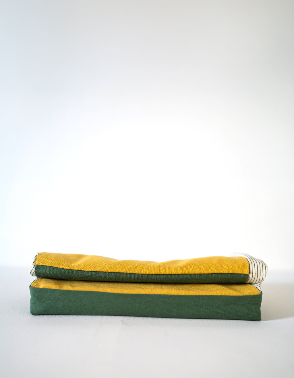 Folded flat bread bag in green and yellow, on a white background