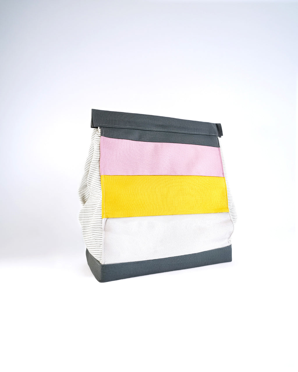 Colorful striped bag with black trim on a light gray background