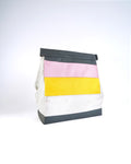 Colorful striped bag with black trim on a light gray background
